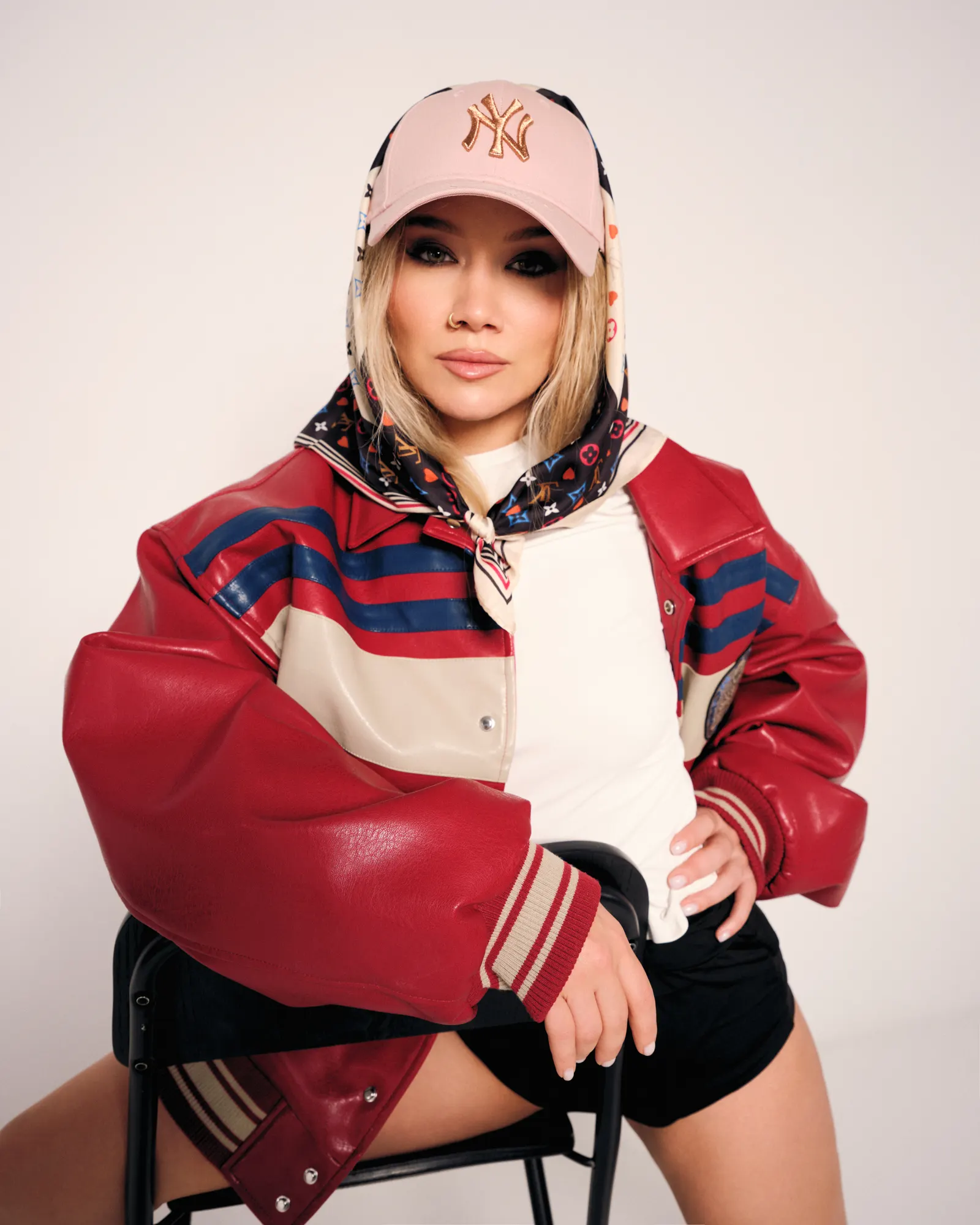 Simona Mereu așezată, geacă varsity roșie